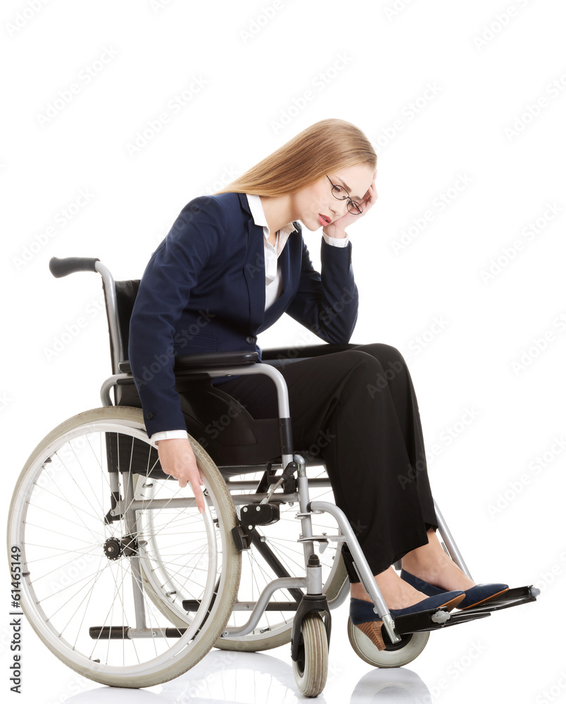 Sad, serious business woman sitting on wheelchair. Sad, serious business woman sitting on wheelchair.