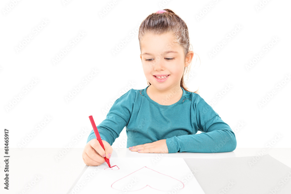Little girl drawing hearts to a blank piece of paper Little girl drawing hearts to a blank piece of paper