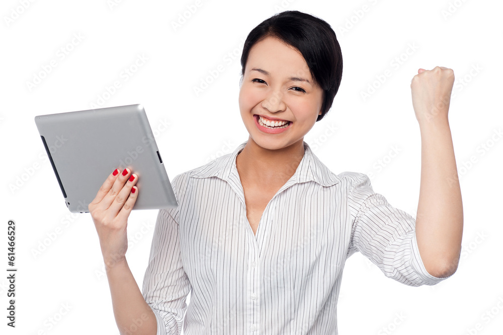 Excited businesswoman holding touch pad Excited businesswoman holding touch pad