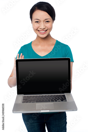 Salesgirl presenting brand new laptop for sale