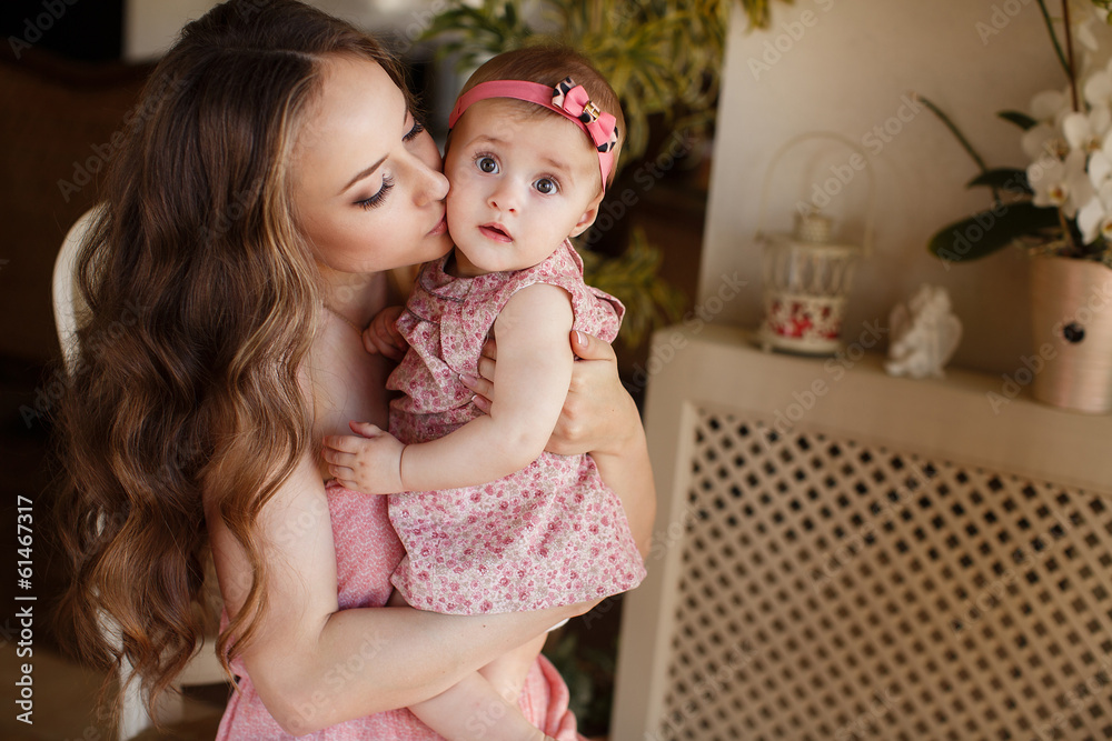 Portrait of a young mother and little daughter Portrait of a young mother and little daughter