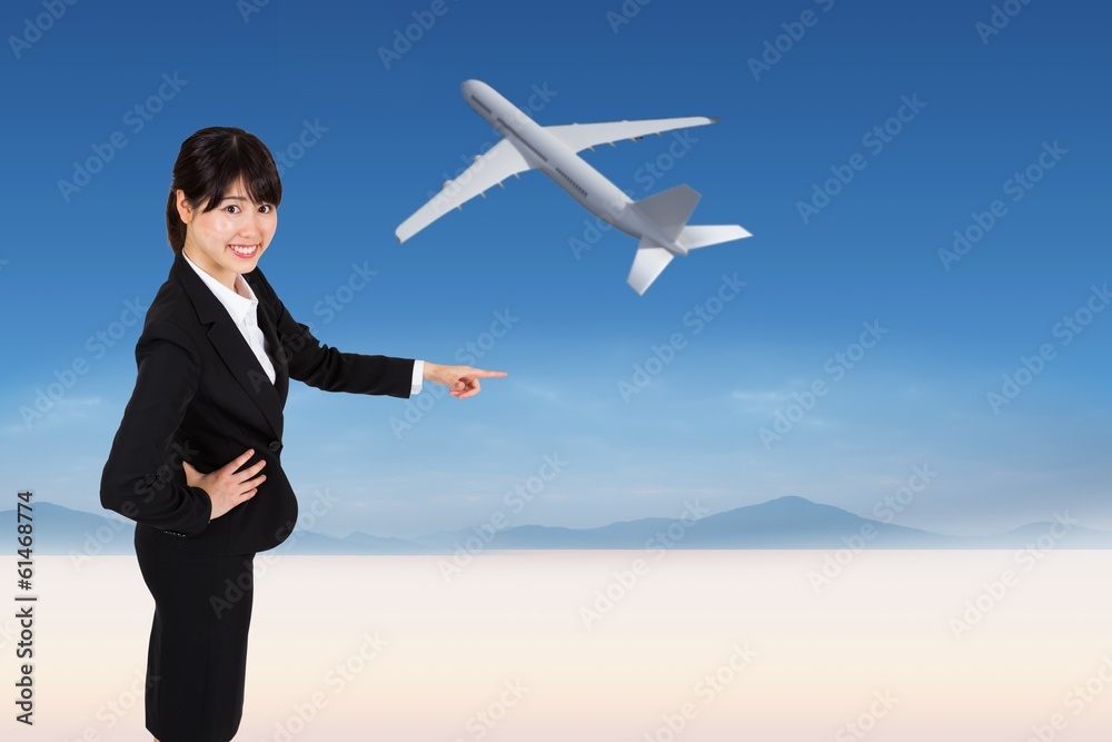 Composite image of smiling businesswoman pointing Composite image of smiling businesswoman pointing