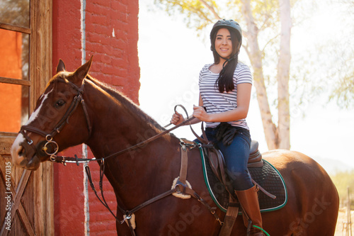 Cute Latin girl riding a horse © AntonioDiaz