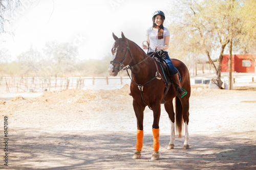 Cute girl horseback riding