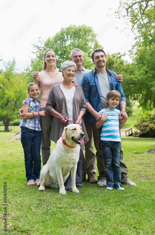 Obraz premium Happy extended family with pet dog at park