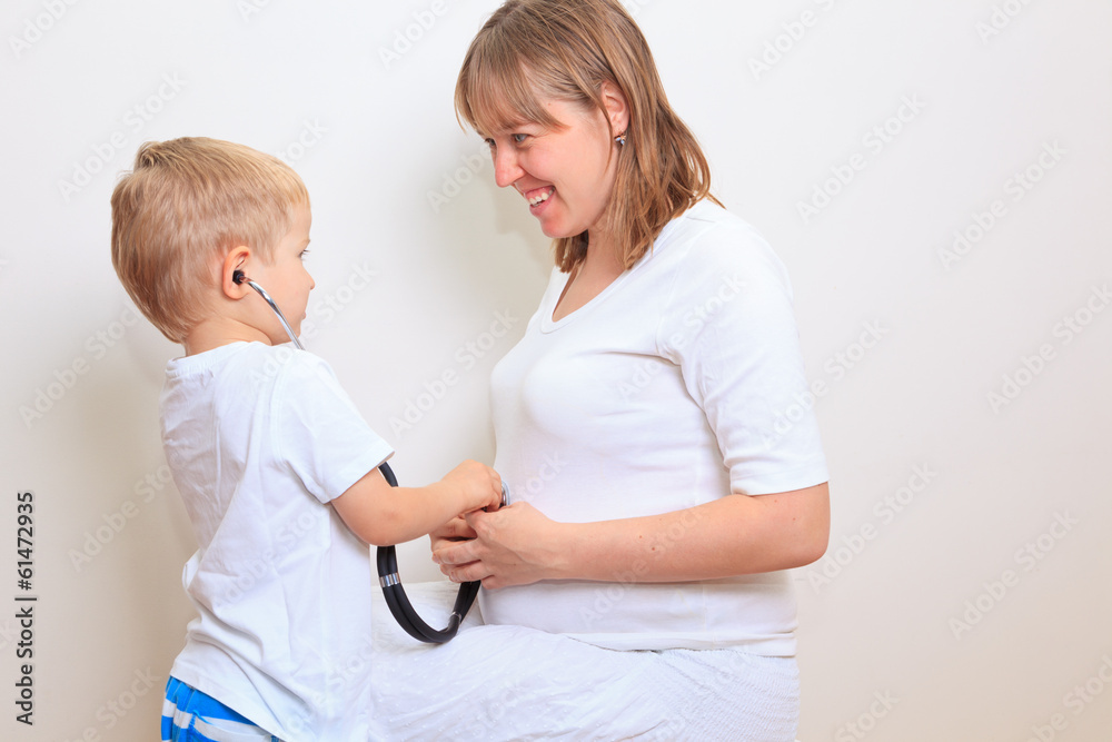 Little boy excited about her coming sibling Little boy excited about her coming sibling