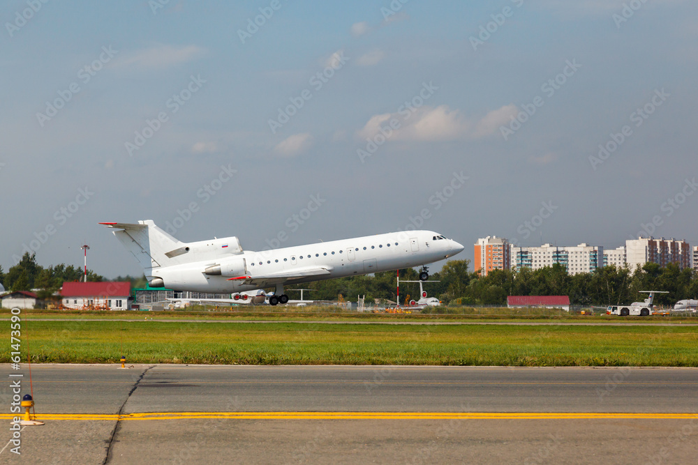 Fototapeta premium white plane takes off from the runway