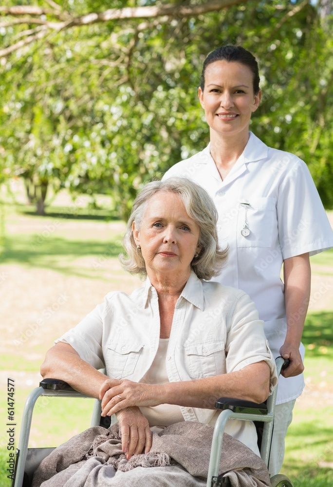 Woman with her mother sitting in wheel chair at park