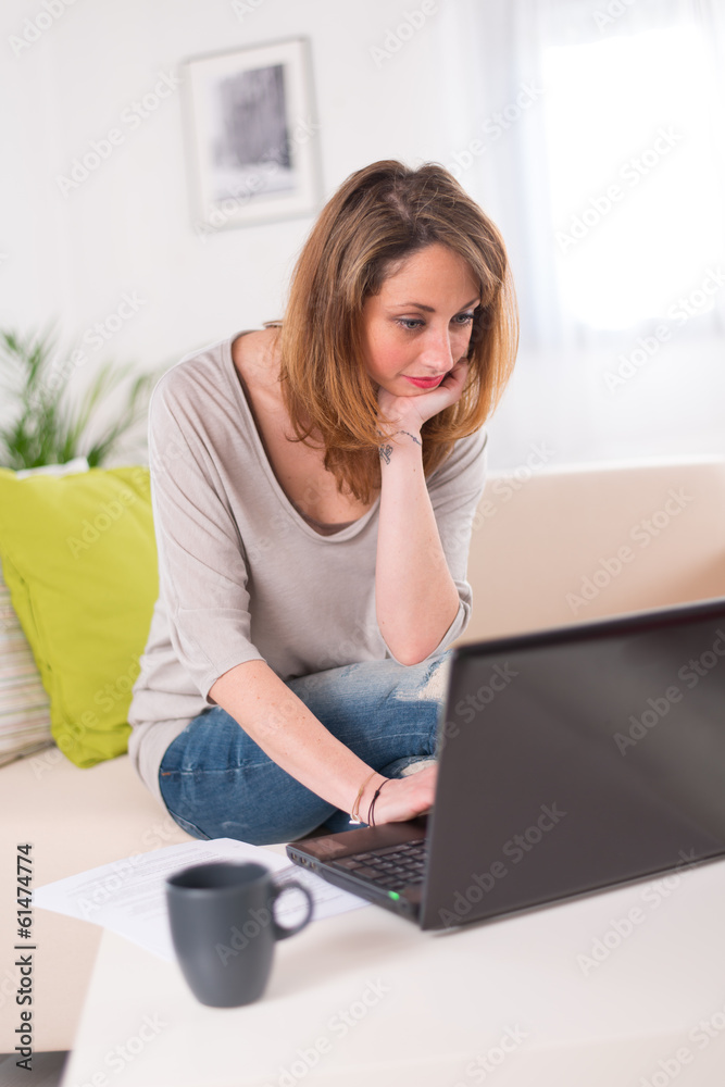 Cheerful young women at home with laptop Cheerful young women at home with laptop