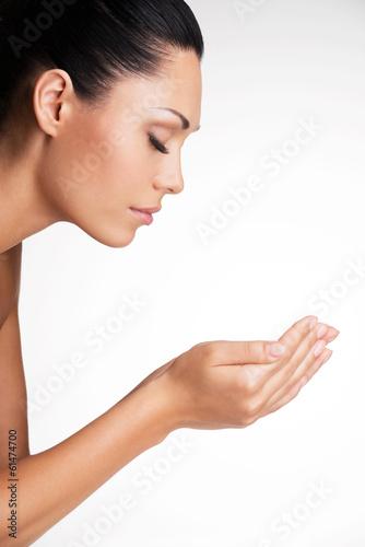 portrait of a beautiful young woman with hands at face