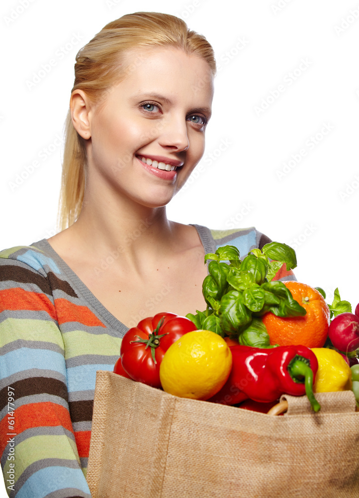 Young woman with a grocery shopping bag. Isolated on white backg Young woman with a grocery shopping bag. Isolated on white backg