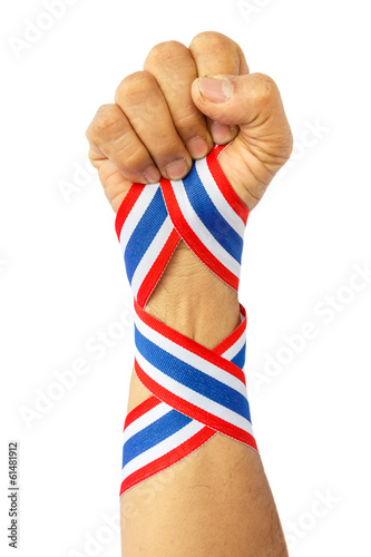 thai man fist and bind thai flag pattern ribbon on forearm photo