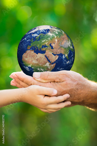 Child and man holding Earth in hands