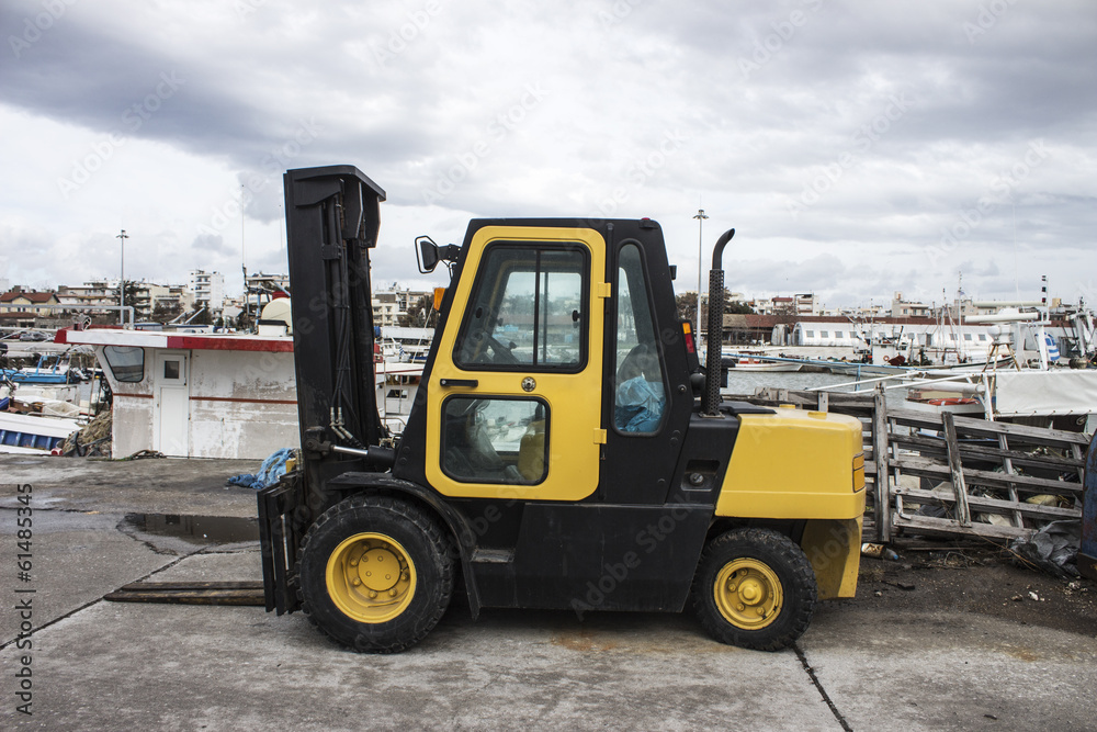 Yellow forklift in harbor