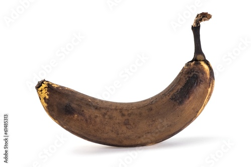 Side view of old overripe banana on white background