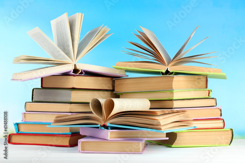 Stacks of books on table on natural background