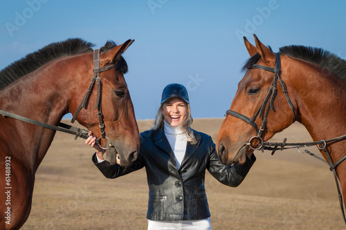 Horsewoman and two horses