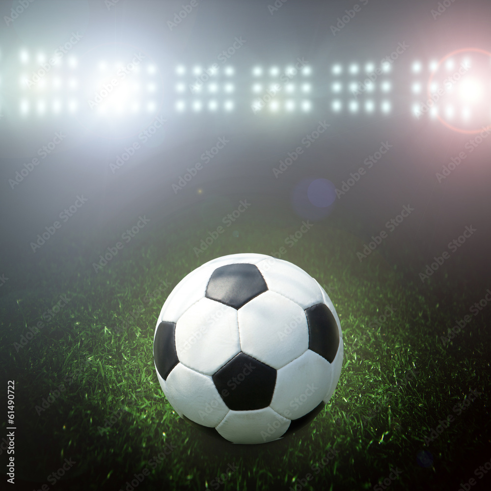 Naklejka premium Soccer ball on the field of stadium with light
