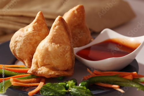 Samosa is an Indain fried or baked pastry with a savory filling photo