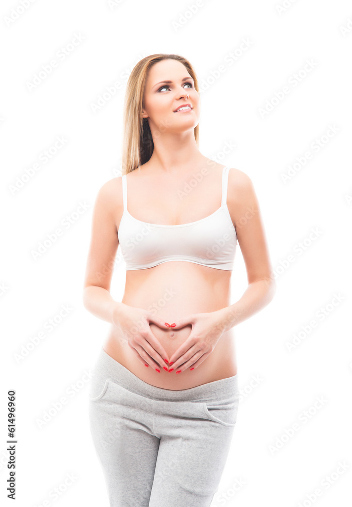 A young blond pregnant woman in white sporty clothes A young blond pregnant woman in white sporty clothes