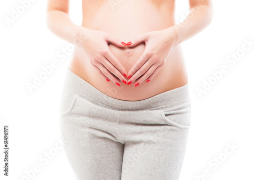 A pregnant woman in grey sporty clothes photo