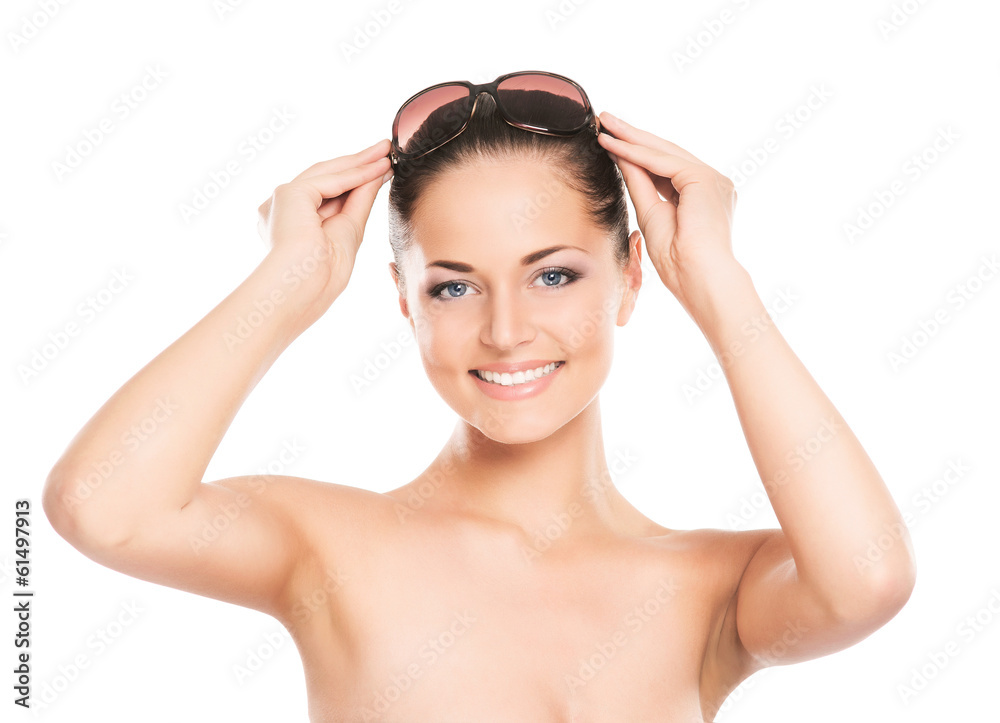 An attractive woman in sunglasses isolated on white An attractive woman in sunglasses isolated on white