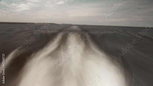 time lapse Waves generated in ship sailing on river photo