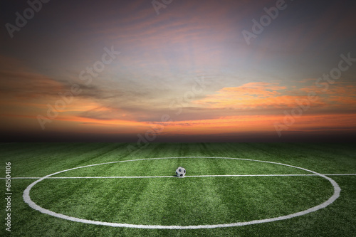 Soccer green grass field at sunset