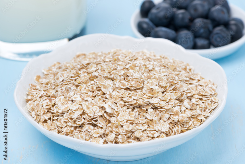 oat flakes, fresh blueberries and milk for breakfast, close-up oat flakes, fresh blueberries and milk for breakfast, close-up