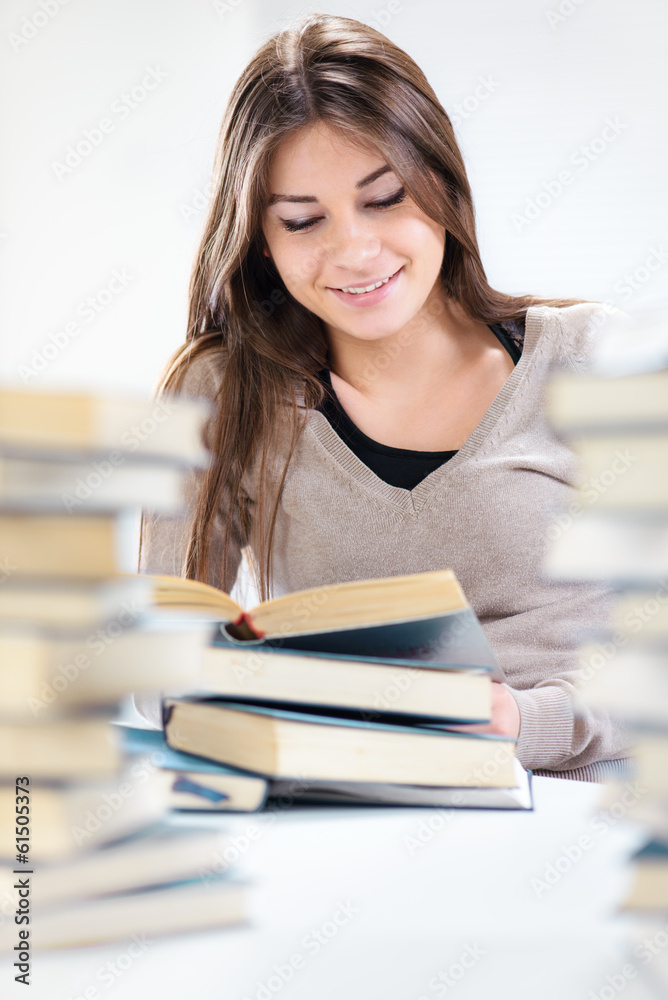 Beautiful Student girl learning between many books Beautiful Student girl learning between many books