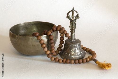 Singing bowls with prayer beads and bell photo