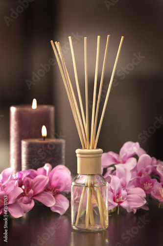 air freshener sticks at home with flowers and ou of focus backgr