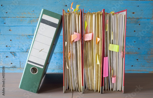 row of file folders with messy documents photo