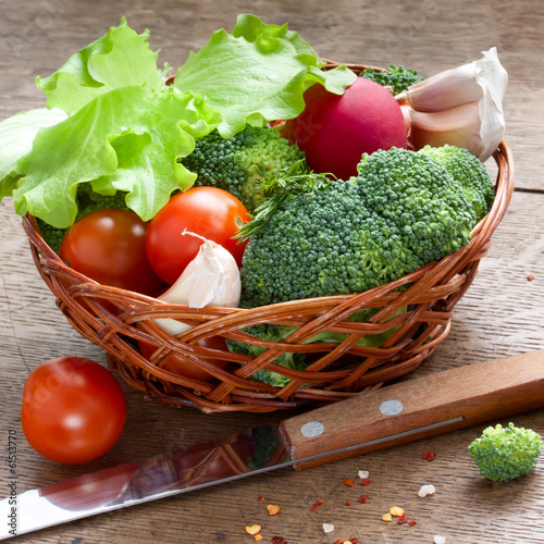 vegetables in the basket on a wood table