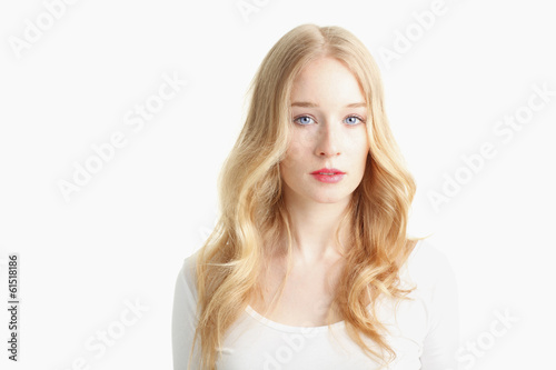 Close-up of a beautiful young woman smiling on white background