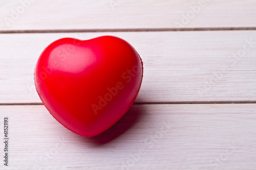 Red heart on old wooden table 