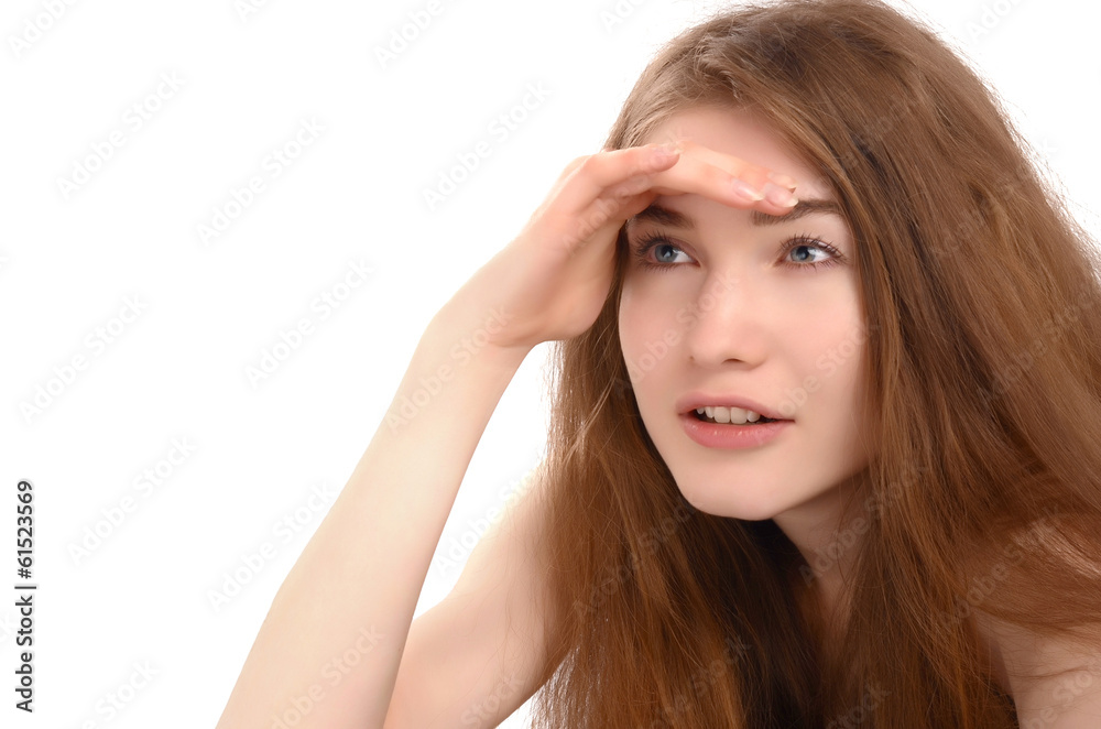 Young woman holding her hand at the forehead looking far away. Young woman holding her hand at the forehead looking far away.
