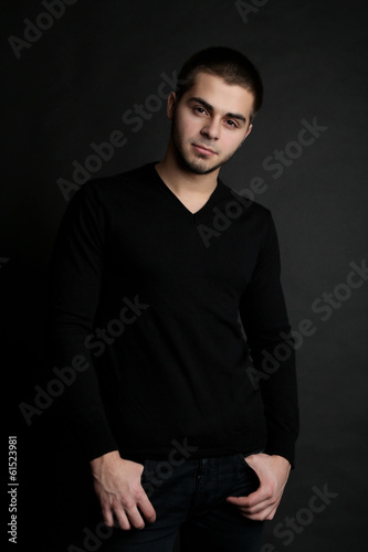 Handsome young man on dark background