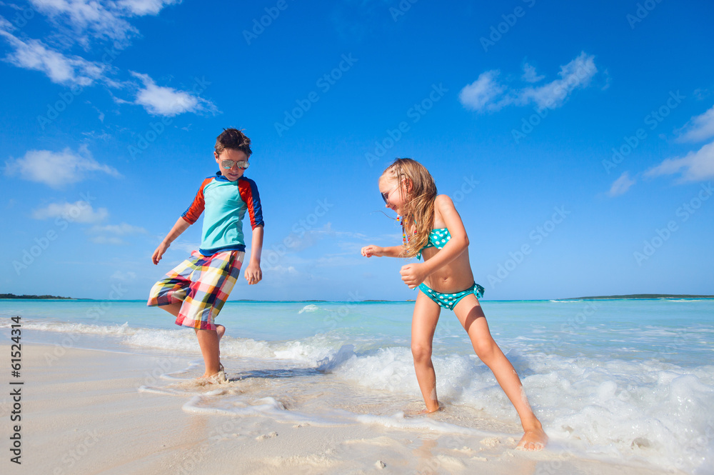 Happy kids dancing at beach