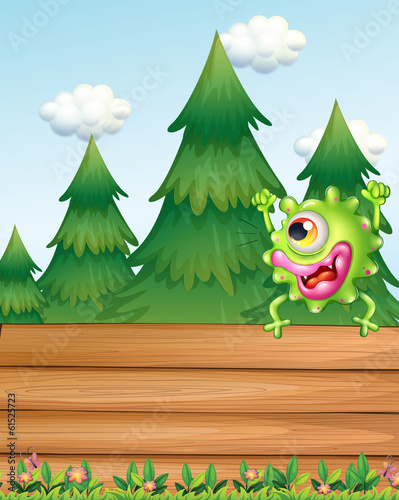 A monster above the wooden signboard