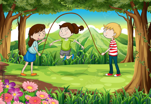 Three kids playing with a rope in the middle of the forest