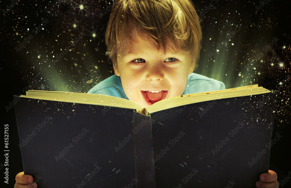 Small boy carrying a magic book - obrazy, fototapety, plakaty 