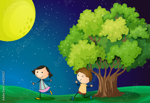 A girl and a boy playing under the bright fullmoon