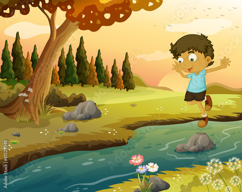 A boy playing at the flowing water