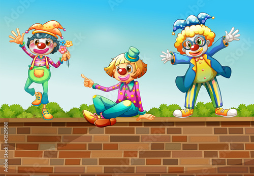 Three clowns above the wall