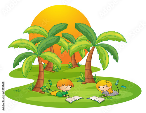 Two kids in the island reading near the coconut trees