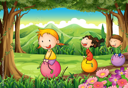 Kids playing with their bouncing balloons at the forest