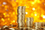 Coins stack on golden bokeh background