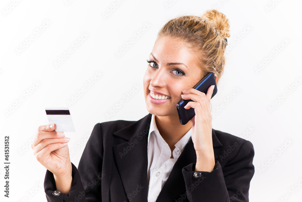 Businesswoman telephoning and holding a credit card. Businesswoman telephoning and holding a credit card.