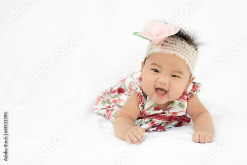 Cute baby smiling girl with rose headband